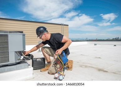 HVAC Technician, Wearing Safety Gear, Observing A Condenser With A Frozen Suction Line, Outdoors On A Rooftop