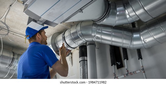 hvac worker install ducted pipe system for ventilation and air conditioning. copy space