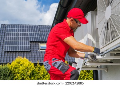 HVAC Worker Performing Heat Pump Maintenance. Device is Transferring Thermal Energy From the Outside Using the Refrigeration Cycle. Home Heating Technologies. - Shutterstock ID 2202142885