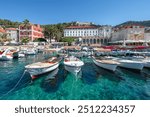 Hvar Island, Croatia. View of the old town with moored boats in the harbor. 