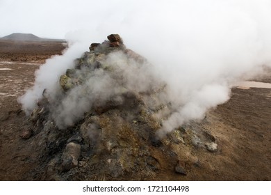 HVERIR, ICELAND - SEPTEMBER 22, 2018: Hot Steam Vents At The Hverir Geothermal Area Near Lake Myvatn In Northern Iceland. Grey And Overcast Day. Sulfur Smell. Otherworldly Landscape.