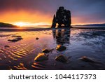 Hvitserkur is a spectacular rock in the sea on the Northern coast of Iceland. Legends say it is a petrified troll. On this photo Hvitserkur reflects in the sea water after the midnight sunset.