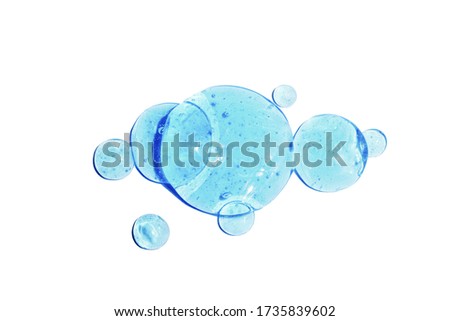 Hyaluronic acid cosmetic gel. Gel texture with bubbles on a blue background. Transparent smear of gel. Close-up, macro
