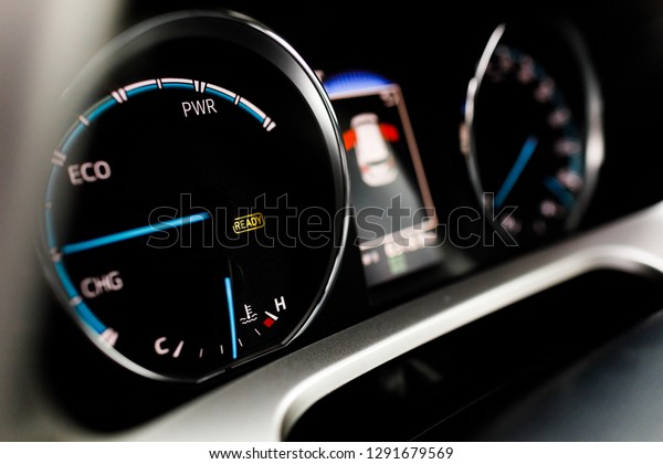 Hybrid car dashboard\
speedometer tachometer with full energy level. Digital dashboard of\
a modern car.