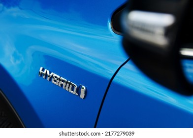 Hybrid emblem on the hybrid blue car