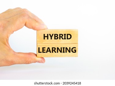 Hybrid learning symbol. Concept words 'Hybrid learning' on wooden blocks on a beautiful white background. Businessman hand. . Business, educational and hybrid learning concept, copy space.