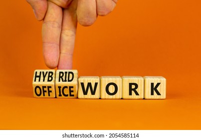 Hybrid Or Office Work Symbol. Businessman Turns Cubes And Changes Words 'office Work' To 'hybrid Work'. Beautiful Orange Background. Business, Hybrid Or Office Working Concept, Copy Space.