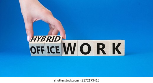 Hybrid Work And Office Work Symbol. Businessman Hand Turns Wooden Cubes And Changes Words Office Work To Hybrid Work. Beautiful Blue Background. Business And Success Concept. Copy Space