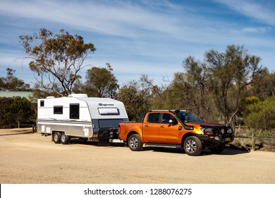 HYDEN, WESTERN AUSTRALIA - JULY 1, 2018: Ford Ranger Wildtrack Off Road Pickup Car With Air Intakes And A White Caravan Trailer In Western Australia Prepared For An Adventure.