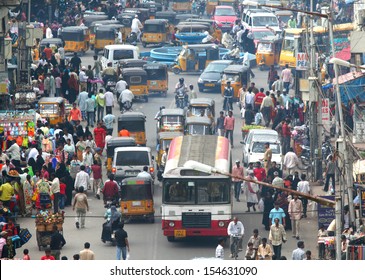 HYDERABAD, ANDHRA PRADESH, INDIA - AUGUST 29: Shoppers and traffic weave about the busy bazaar at the Charminar on August 29 2012. The area is one of the most densely populated in the city.