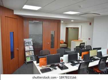 Hyderabad, India - January 19, 2021: Modern Manager Office Interior With Redwood Interior Designs And White Walls, Stylish Tables, Chairs, And Painting.