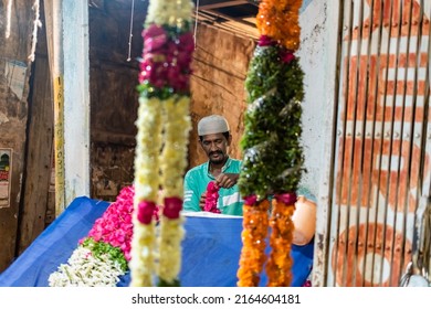 Hyderabad, India - September 2018: A Muslim Street Vendor At His Shop Selling Flowers In A Market In Old Hyderabad.