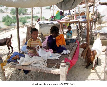 HYDERABAD, PAKISTAN - AUG 27: A flood-affected family from Jaffarabad rest at a relief camp on August 27, 2010 in Hyderabad.