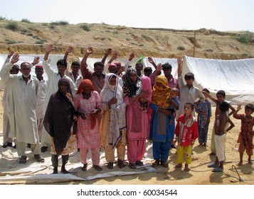 HYDERABAD, PAKISTAN - AUG 27: Flood-affected families from Jaffarabad  gather to protest against non-supply of basic facilities at a relief camp on August 27, 2010 in Hyderabad.