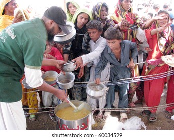 HYDERABAD, PAKISTAN - AUG 28: Flood-affected people gather to receive food at relief camp on August 28, 2010 in Hyderabad.