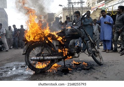 HYDERABAD, PAKISTAN - JUN 16: Members of Anjuman-e-Tahafuz Dukandar are burn motorcycle during protest demonstration against price hike of petroleum products, on June 16, 2022 in Hyderabad.