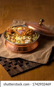 Hyderabadi Chicken Dum Biryani - Marinated chicken drumstick cooked with basmati rice and biryani spices