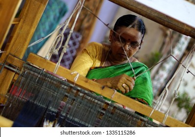 HYDERABAD,INDIA-MARCH 1:view of Indian woman  manually weaving traditional dress on hand loom machine,to make  women,men and general utility textiles,on March 1,2019 in Hyderabad,India   