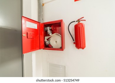 hydrant and fire extinguisher hanging on the wall