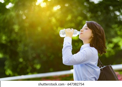 Hydration Concept. A Young Woman Drinking A Bottle Of Water.