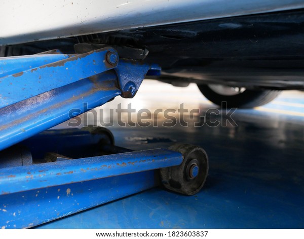 hydraulic car jack to\
lift car at garage.