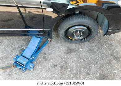 Hydraulic Car Jack Lift Car To Replace Punctured Tyre With Temporary Emergency Replacement Tyre