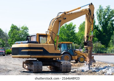 Hydraulic crusher excavator backhoe machinery working on site demolition stone crusher