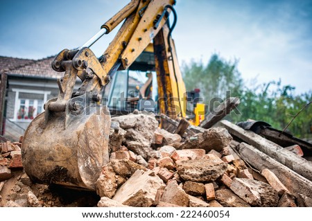 Hydraulic crusher excavator backoe machinery working on site demolition