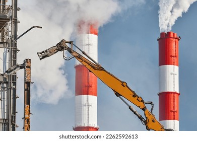 Hydraulic cutter destroys old building against chimneys - Shutterstock ID 2262592613