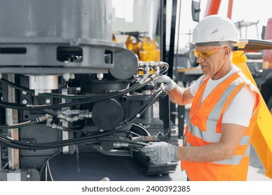 Hydraulic engineer doing safety check on new installation hoses of modern drilling industrial machine. - Powered by Shutterstock