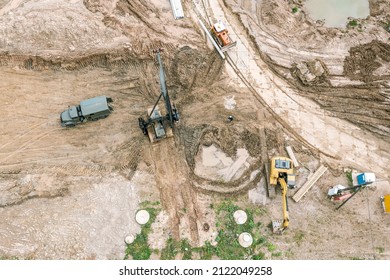 Hydraulic Hammer Pile Driving Machine Standing At Construction Site And Ready For Work. Aerial Overhead View.