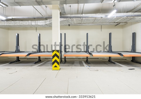 Hydraulic\
lifts for the car in the underground\
parking.