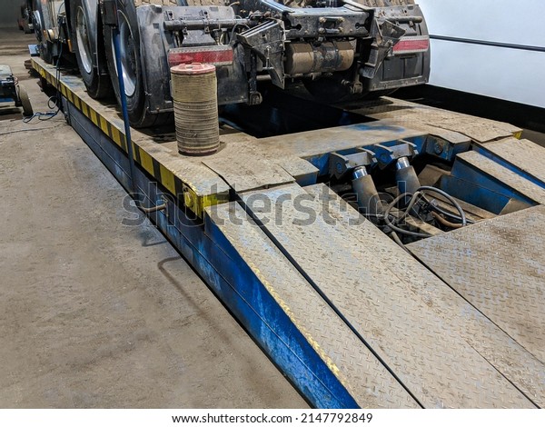 A hydraulic platform for lift cargo truck. Planned\
maintenance of cars.