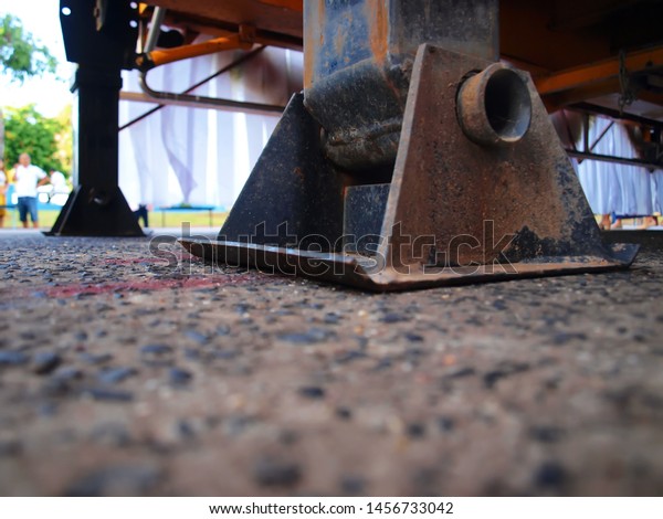 Hydraulic supports of trucks Supports\
hydraulic cranes Hydraulic crane support on the concrete floor For\
the stability of the truck. selective\
focus