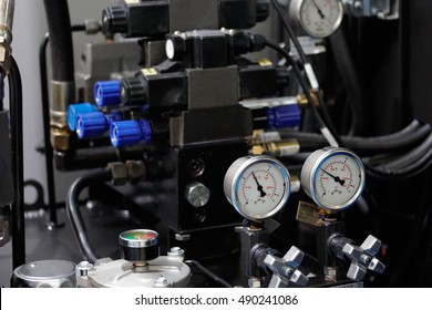 Hydraulic system of cnc machining center with gauges to control pressure. Selective focus.