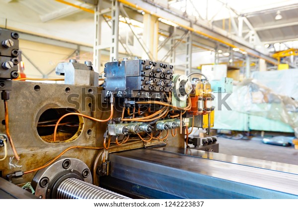 The
hydraulic system on the machine, copper oil tubes connected to the
equipment in production. Bed for guides under the influence of the
hydraulic system. Abstract industrial
background