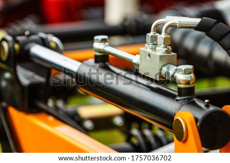 Hydraulic system on modern heavy machine. Industrial detail piston in machinery. Technology.