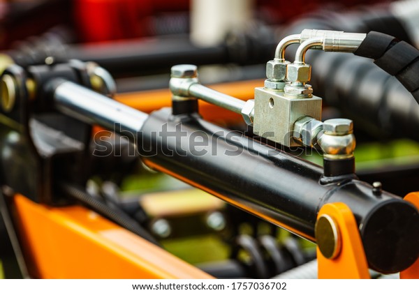Hydraulic system on modern heavy\
machine. Industrial detail piston in machinery.\
Technology.
