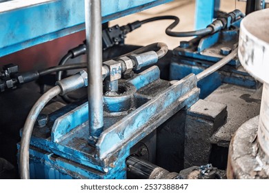 A hydraulic system operates efficiently in an industrial setting, highlighting intricate components and design typically found during production. - Powered by Shutterstock