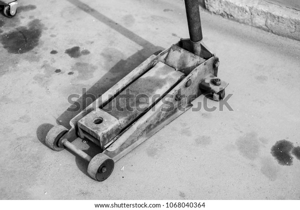 Hydraulic\
trolley for moving cargo black and white\
photo