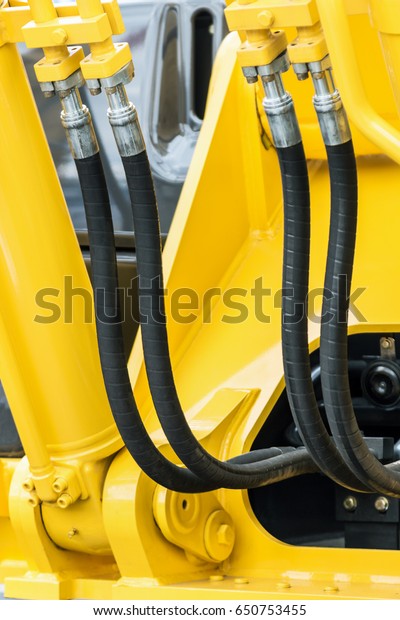 hydraulics pipes and nozzles,\
tractor or other construction equipment. focus on the hydraulic\
pipes