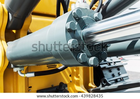 hydraulics tractor yellow. focus on the hydraulic pipes