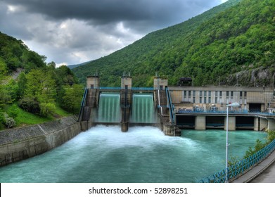 Hydro Electric Electricity Power Plant  - Powerplant Waterfall Over Dam After Storm