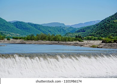 Hydro Power Plant On The Tskhenistsqali River Against A Backdrop Of Forested Mountains And A Blue Sky, Georgia (Europe), Caucasus                              