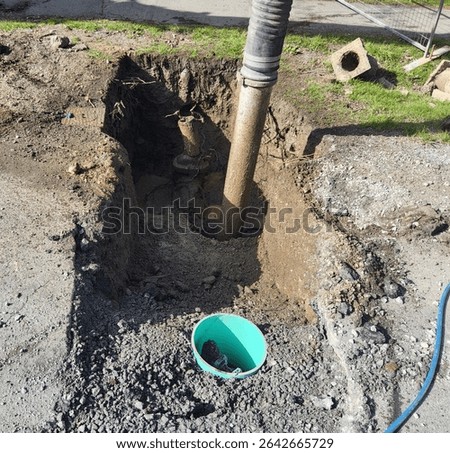 Hydro vacuum unit in operation to safely uncover an old water main during utility investigation work on gravel surface.
