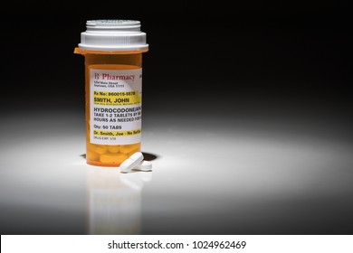 Hydrocodone Pills And Prescription Bottle With Non Proprietary Label. No Model Release Required - Contains Ficticious Information.