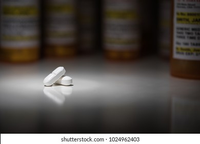 Hydrocodone Pills and Prescription Bottles Under Spot Light.