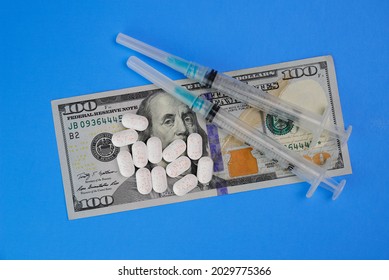 Hydrocodone Tablets With Syringes And A Hundred Dollar Bill. Opiate Addiction Costs The U.S. Economy $78.5 Billion Per Year.