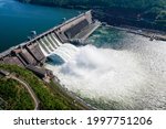 Hydroelectric dam on the river, water discharge from the reservoir, aerial photography