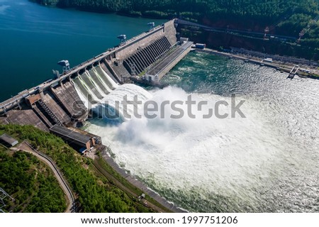 Hydroelectric dam on the river, water discharge from the reservoir, aerial photography